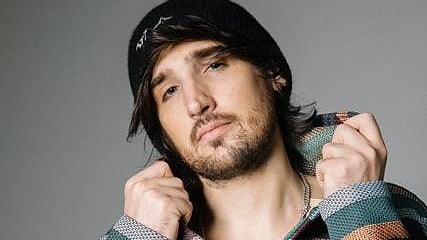 Man in a beanie and patterned hoodie.