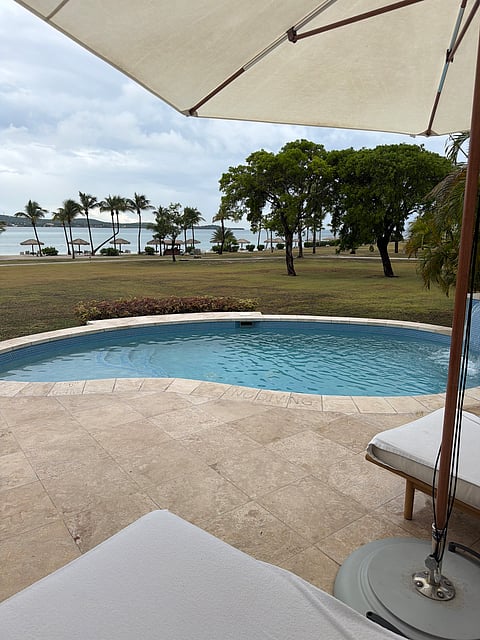 Villa 26's private plunge pool and shaded terrace overlooking the beach at Jumby Bay Island