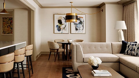 Townhouse-style living room with leather seating and abstract-print carpet in a Back Bay suite