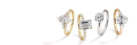 Four diamond rings displayed against a white background.
