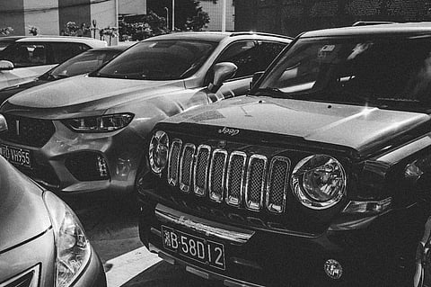 Parked cars in black and white.