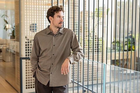 Man leaning against a modern railing.