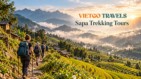 Hikers on a trail through terraced rice fields.