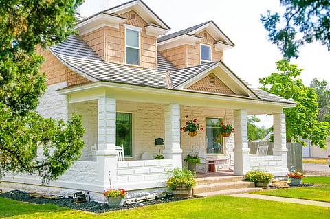 Two-story house with a white stone front porch.