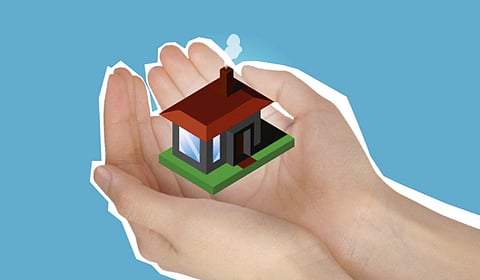 Hands cupping a small illustrated house.