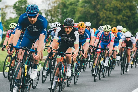 Peloton of cyclists racing.
