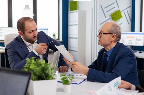 Businessmen discussing a document.   