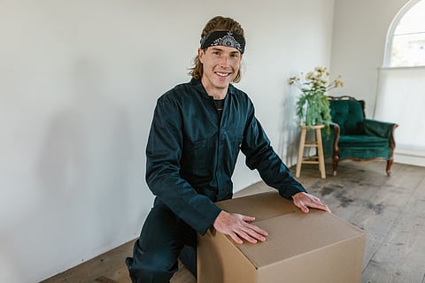 Man kneeling with a cardboard box