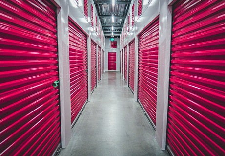 Hallway of red storage units.