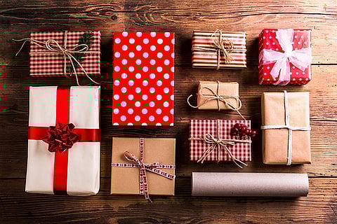 Christmas presents laid on a wooden table background