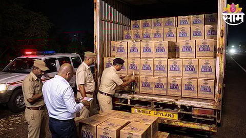 Excise officials inspect the truck after seizing fake Goa-made liquor worth ₹1.30 crore on Kolhapur highway.