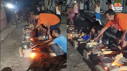 Workers cooking on wooden stove