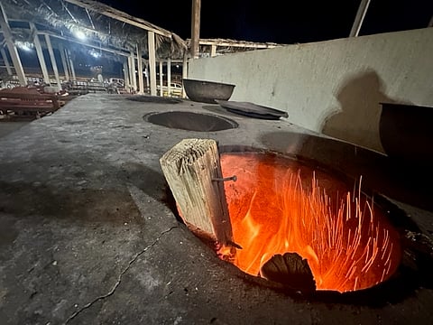 مطاعم شعبية تستخدم ألواح الخشب من بقايا بناء التسليح للطهي بساحل عسير