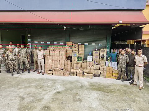Officers with seized liquor