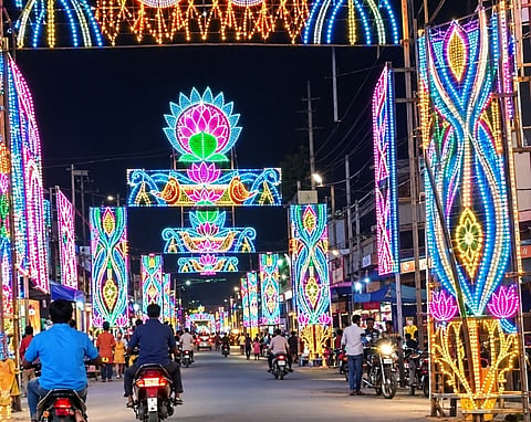 जामुड़िया : शारदीय नवरात्र के तीसरे दिन ही जामुड़िया बाजार का शहरी क्षेत्र रंग-बिरंगी रोशनी से जगमगा उठा है। आपायन भवन से पुनियाटी तक सड़क के दोनों ओर आकर्षक विद्युत सज्जा, रंगीन रोशनी और भव्य स्वागत द्वारों ने पूरे क्षेत्र की रौनक बढ़ा दी है। दुर्गापूजा को लेकर बाजार में उत्सव का माहौल बन गया है और खरीदारी के लिए लोगों की भीड़ उमड़ने लगी है।
जामुड़िया बाजार क्षेत्र में इस वर्ष सात से अधिक पूजा समितियों की ओर से दुर्गापूजा का आयोजन किया जा रहा है। इनमें श्री दुर्गा सेवा समिति, थानामोड़ सार्वजनिक दुर्गापूजा कमेटी, 11 नंबर दुर्गापूजा कमेटी, बाउरीपाड़ा पूजा कमेटी, पावर हाउस स्थित रिक्रिएशन क्लब, पुनियाटी पूजा कमेटी, दामोदरपुर पूजा कमेटी तथा आरएनएस क्लब पूजा कमेटी प्रमुख हैं। सभी पूजा समितियों की ओर से पंडालों को आकर्षक रूप देने के साथ ही विद्युत सज्जा पर विशेष ध्यान दिया जा रहा है।
इन पूजा पंडालों का उद्घाटन महाषष्ठी के दिन किया जाएगा। वहीं, पूजा की तैयारियों के बीच बाजार की रौनक लगातार बढ़ रही है। कपड़े, जूते-चप्पल, सजावटी सामान और अन्य जरूरी वस्तुओं की दुकानों पर ग्राहकों की आवाजाही बढ़ गई है। लोग परिवार के साथ बाजार पहुंचकर जमकर खरीदारी कर रहे हैं।
इस वर्ष राज्य में सत्ता परिवर्तन का असर भी पूजा पंडालों की सजावट और आयोजन के माहौल में चर्चा का विषय बना हुआ है। नवरात्र के शुरुआती दिनों में ही जामुड़िया बाजार की चहल-पहल और आकर्षक रोशनी ने दुर्गोत्सव के उल्लास को और बढ़ा दिया है।