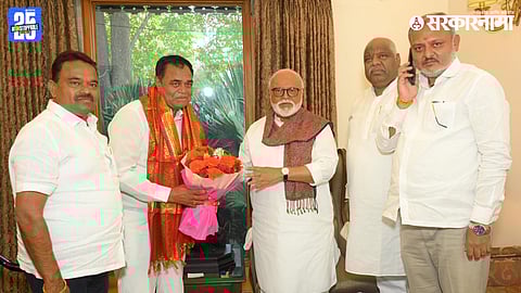 Newly elected Lasalgaon Market Committee chairman D.K. Jagtap receiving blessings from Chhagan Bhujbal