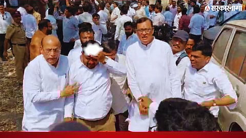 Police and political workers present at the scene after a clash between BJP and Congress workers in Pune.

