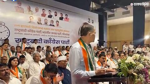 Sharad Pawar’s image displayed on a banner during Sunetra Pawar’s NCP gathering, drawing political attention.