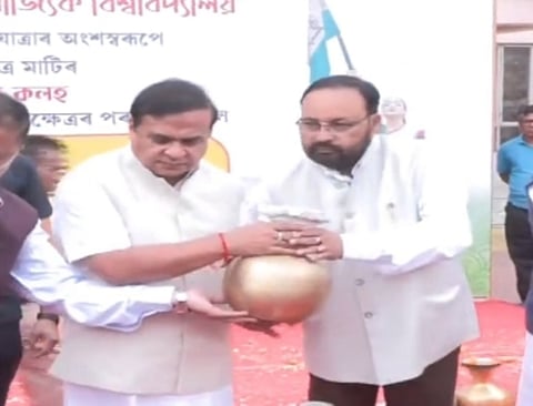 Image of Assam Chief Minister Himanta Biswa Sarma while passing the Kalash to Minister Keshab Mahanta during the Amrit Kalash initiative 