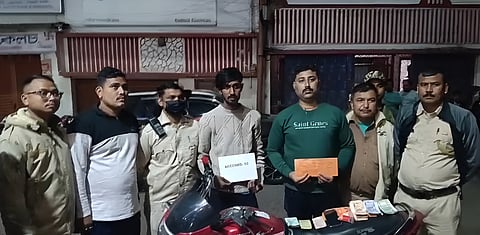 Image of the accused alongside the police officials