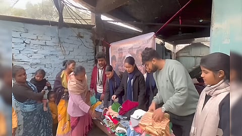 Image of the volunteers of 'Sarathi' while distributing clothes