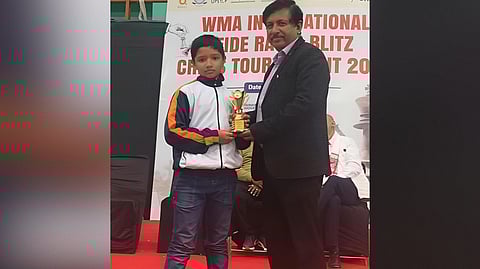Image of Avaneesh Kashyap while receiving the trophy