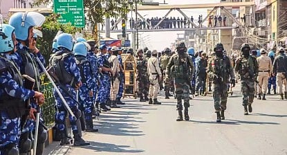 Tensions soar and houses are set ablaze after a mother of five is fatally shot during protests over the arrest of village volunteers