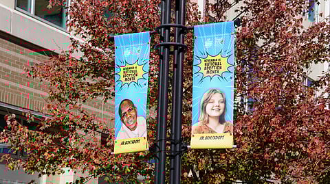 Banners of children waiting to be adopted are displayed on lamp posts along Main Street in downtown Little Rock.