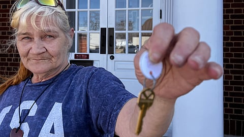 Christine holding the keys to her home