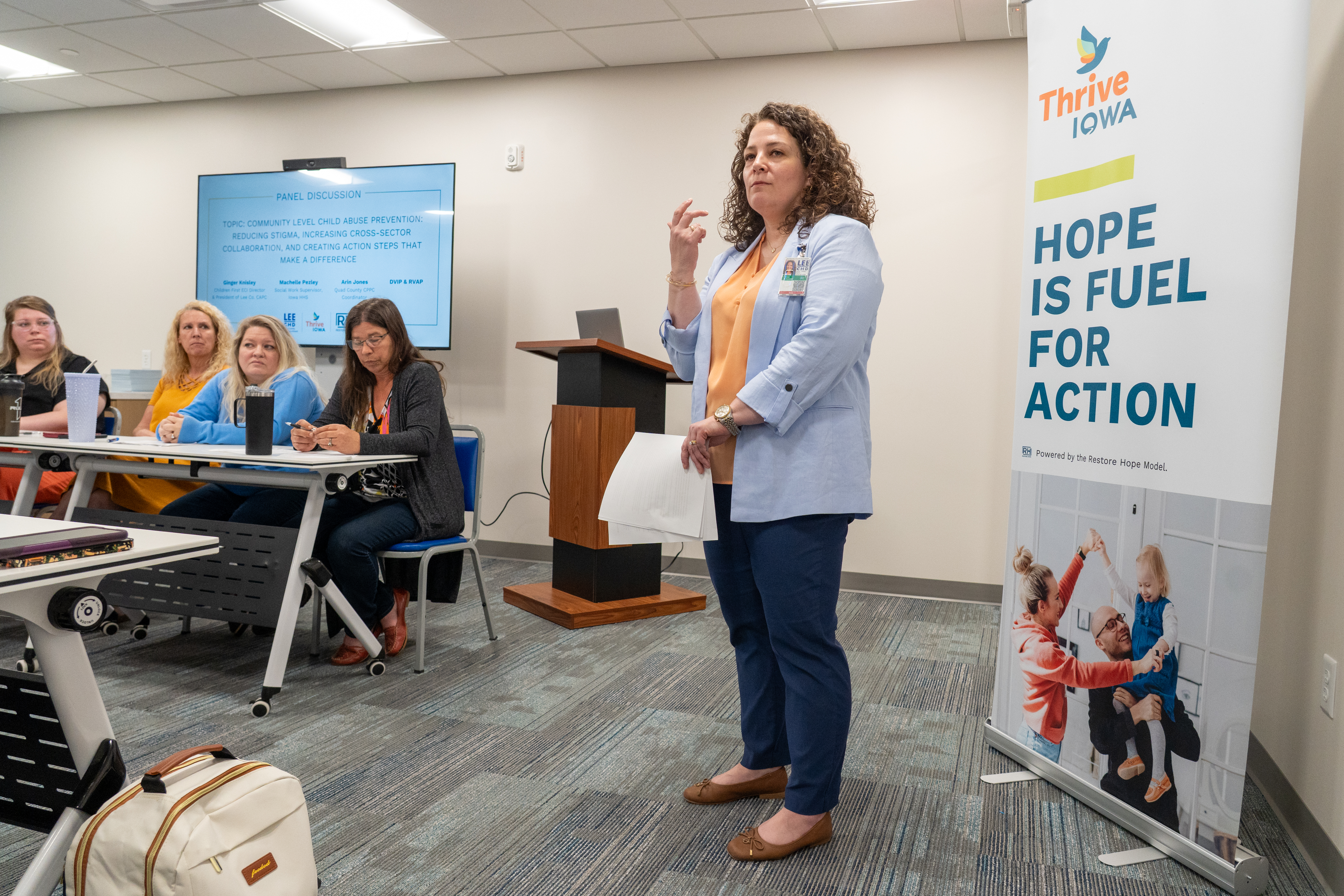 Tessa Schroeder, coordinator of Thrive Iowa of Lee County, leads a panel of experts during a conversation about curbing child abuse in Lee County during an alliance meeting in Fort Madison.