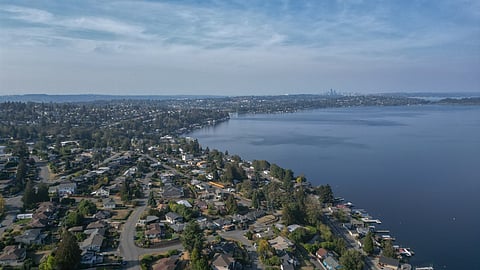 An aerial view of Rainier Beach with downtown Seattle in the distance and Lake Washington.