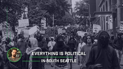 Seattle protest against ICE with demonstrators holding signs like “Chinga La Migra” and “No One Is Illegal;” green and white text that reads "Everything Is Political in South Seattle" is overlayed on the photo. 