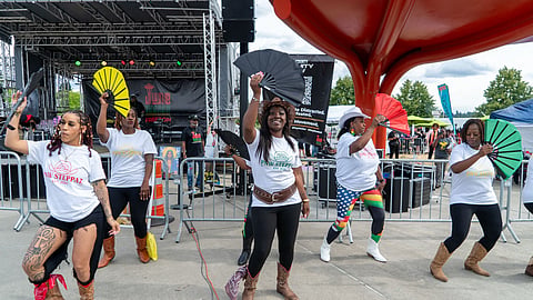 PNW Steppaz dance team performs with fans at Seattle's Juneteenth 2025 Freedom Festival with coordinated choreography outdoors.