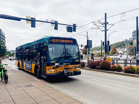 King County Metro Route 106 bus to ID-Chinatown Station in Seattle, pulling into a bus stop near the Othello light rail station.