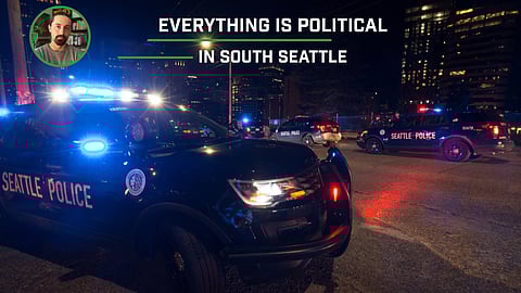 Police cars lit up at night in downtown Seattle.