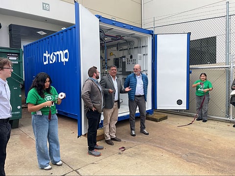 Edwin Alberto Hernández-Reto stands with David Goldberg from the City of Seattle (to his left), Bryce Hesterman from NextCycle Washington (to his right), and youth students with DVSA in front of the biodigester.