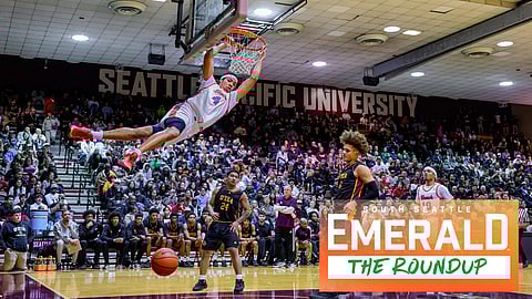 Rainier Beach's Tyran Stokes swings on the rim after delivering a thundering dunk in the Metro League championship game.