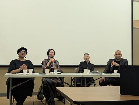 Four panelists seated at a table with microphones during a 37th LD town hall, speaking to an audience in a community meeting room with cups and notes on the table.