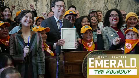 Gov. Bob Ferguson appears with supporters of the bill after signing the legislation into law on March 9, 2026.