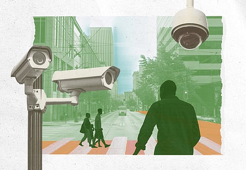 An illustration in green, orange, and white shows pedestrians walking on a city street while surveillance cameras keep watch.