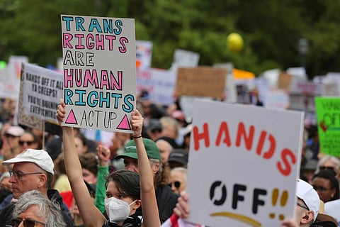 Activists protest Donald Trump's policies, including on trans rights and the creation of DOGE under Elon Musk, at the Hands Off rally at the state capitol on April 5, 2025.