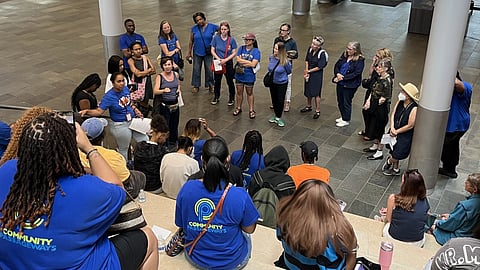 Community Passageways staff, student participants, and community members gather at Seattle City Hall on June 23 before urging Seattle City Council to renew funding for Rainier Beach work.