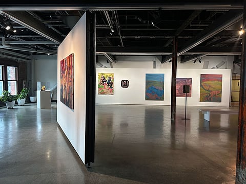 Wide photo of the gallery at King Street Station with "This Room Is Ours" on display