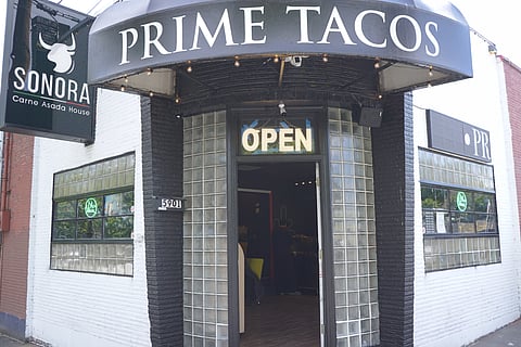 Under an awning that reads "Prime Tacos," a door leads customers to Sonora Carne Asada House.