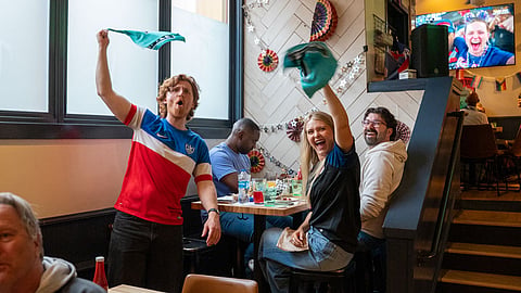 Austin Taylor and Morgan McCorkle celebrate at the Rough & Tumble Pub in Columbia City on June 25 after the U.S. scores against Turkey. Turkey won the match 3–2, but the U.S. had already secured a place in the round of 32. 