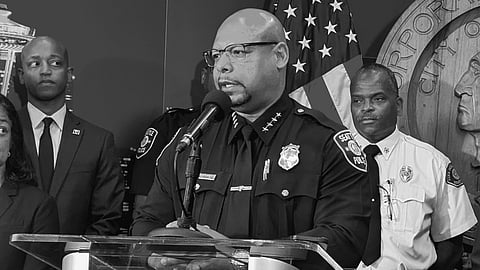 Black-and-white photo of Shon Barnes speaking at a press conference.