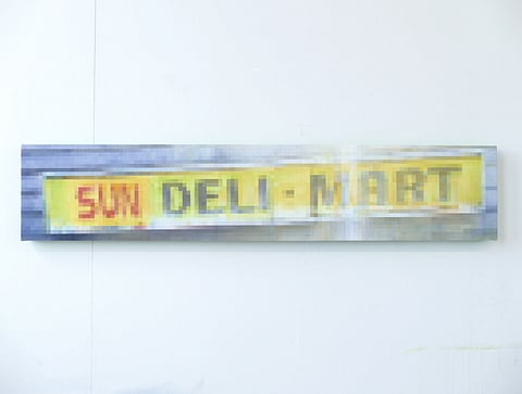 Pixelated photo of local Sun Deli Mart sign.