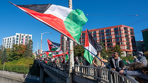 Demonstrators wave Palestinian flags on Pine Street.