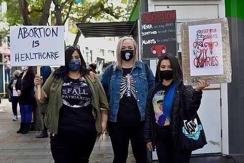 From left to right: protestors Helica, Sam, & Alyssa at Saturday's rally. (Photo: Maile Anderson)