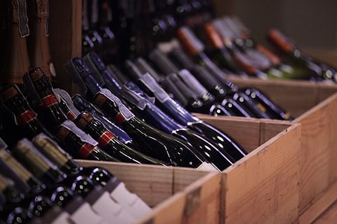 Wine bottles in wood cases in Norwell. 